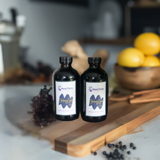 Elderberry Syrup bottles surrounded by herbs and lemons